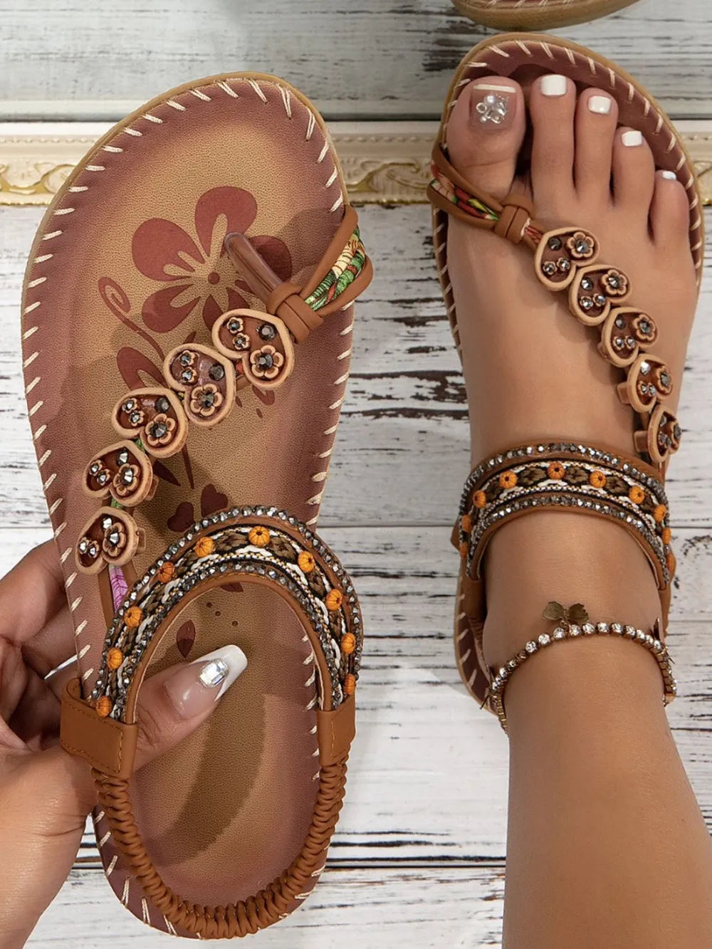 Caramel toe-loop flat sandals with floral beaded appliqué and ankle wrap straps