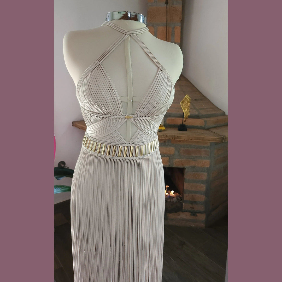Selene ivory dress back close-up: open diamond straps and gold-trim waist band, fringe