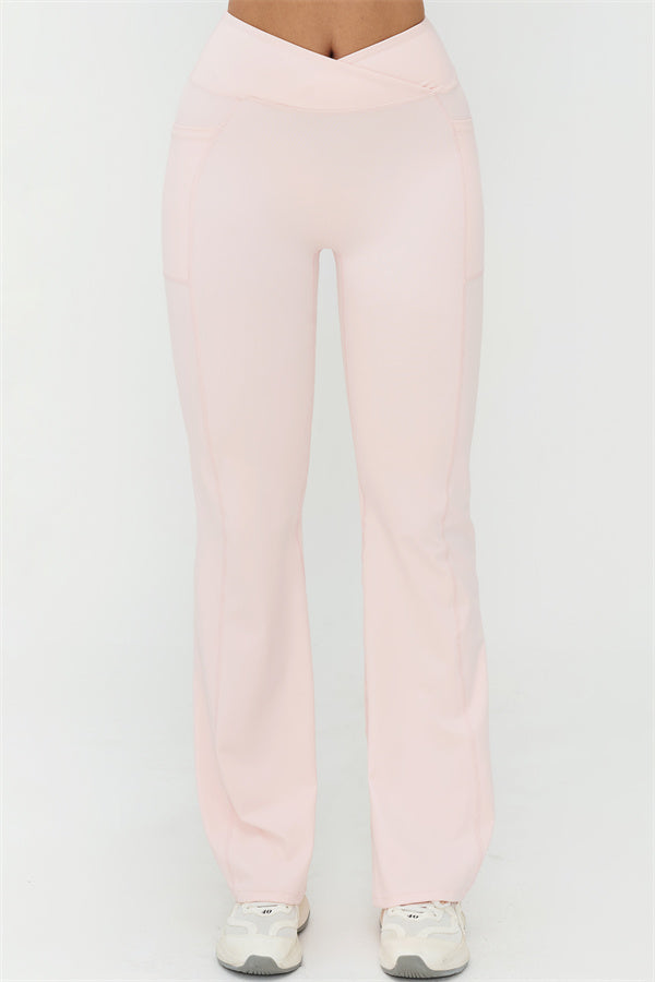 Light pink flared leggings with high-rise waistband and straight back seam, full length