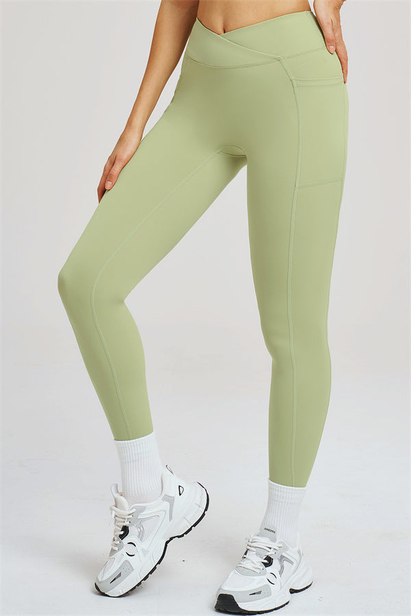 Light olive green leggings with side seam paneling and ankle-length fit