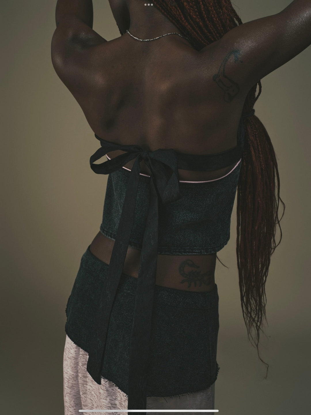 Fei Patch Maxi Skirt close-up back: dark patch with tied bow detail above light pink panel.