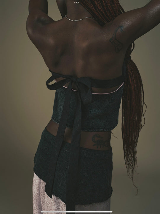 Fei Patch Maxi Skirt close-up back: dark patch with tied bow detail above light pink panel.