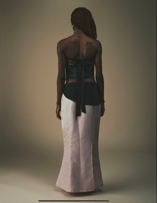 Fei Patch Maxi Skirt back view on model: light pink maxi with dark patch and bow tie.