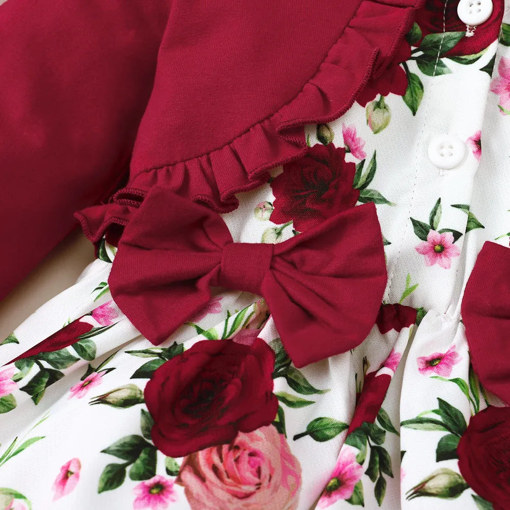 Floral skirt close-up with deep red rosette bow and ruffle trim over white fabric
