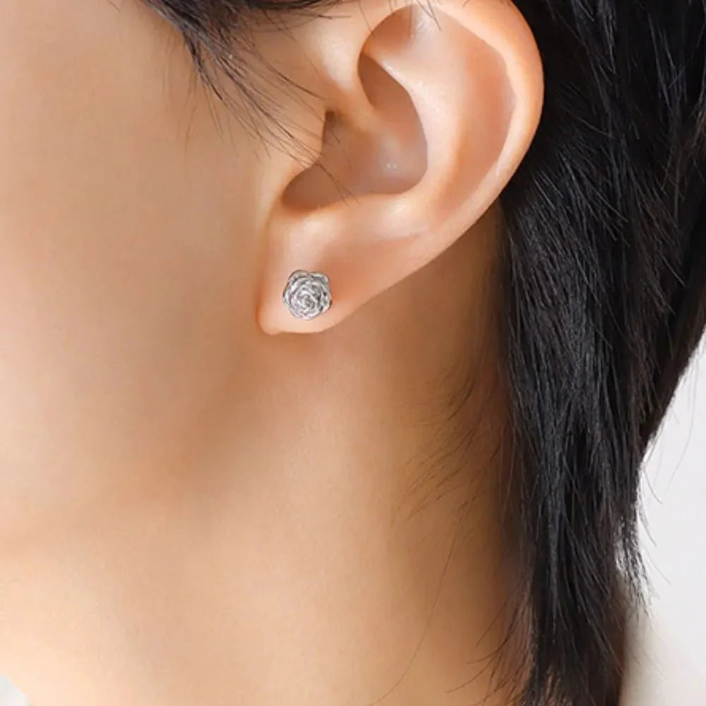 Petal Gleam Studs in silver: textured circular flower stud earrings on ear