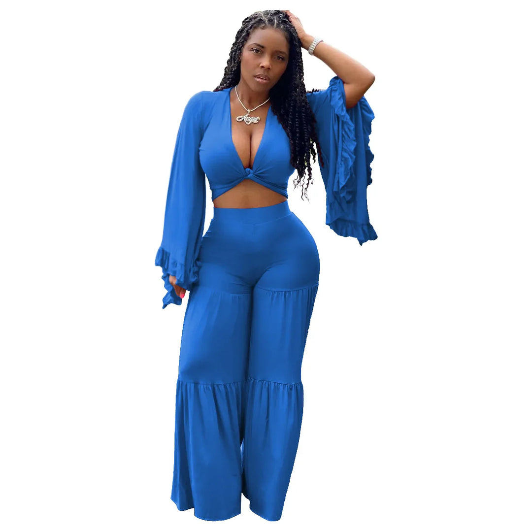 Blue long-sleeve wrap crop top paired with wide-leg tiered trousers