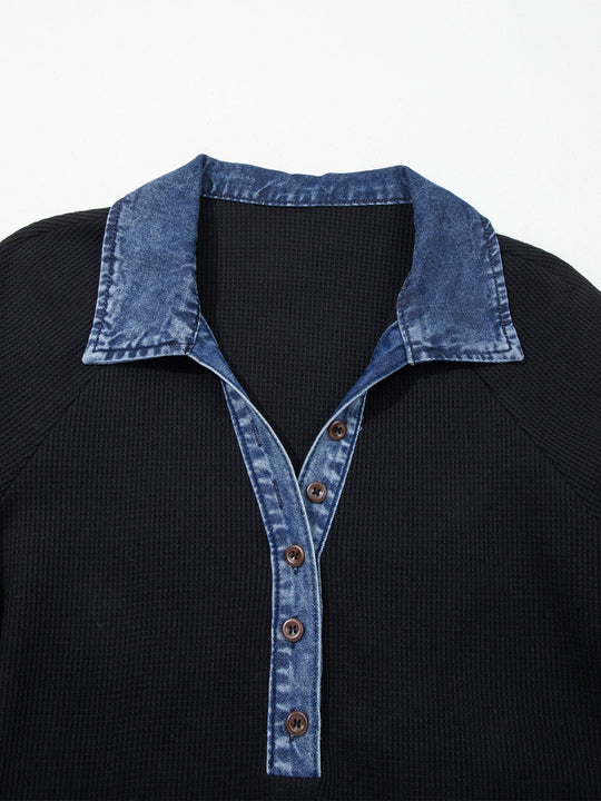 Close-up: black top with denim V placket, brown buttons and collar