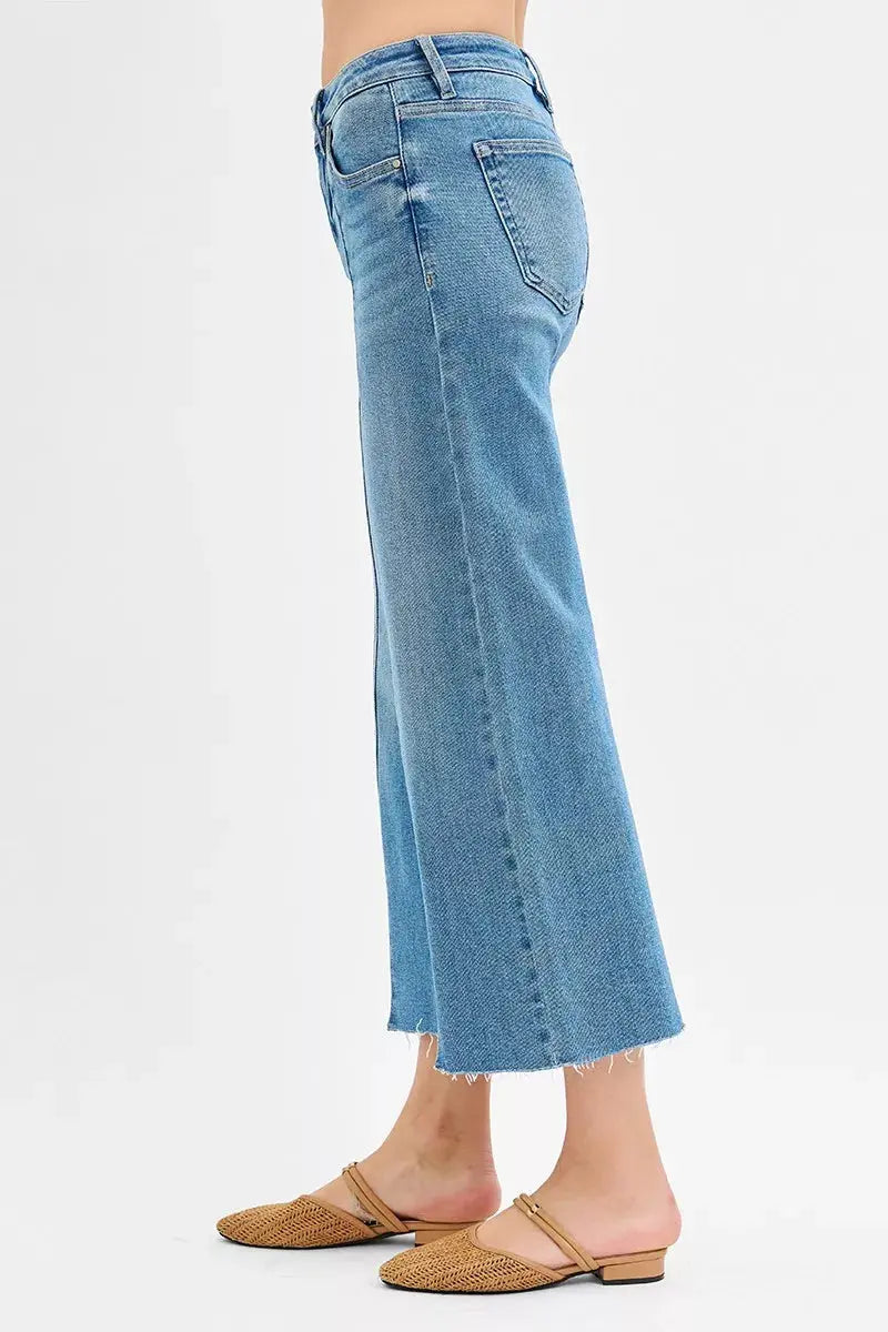 Medium-wash side view of wide-leg crop jeans with stitched front slit