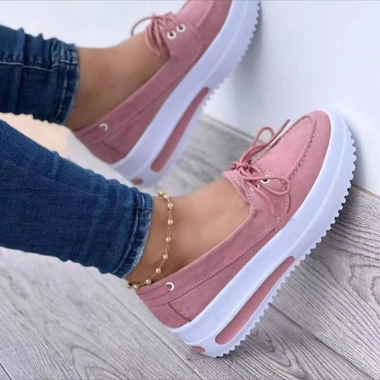 Pink lace-up platform loafers with thick white sole and raised heel