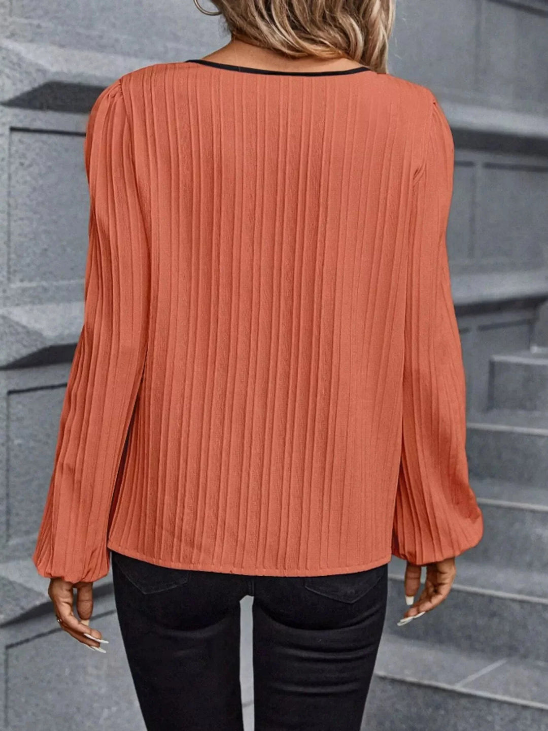 Coral textured blouse back view, long sleeves with gathered cuffs