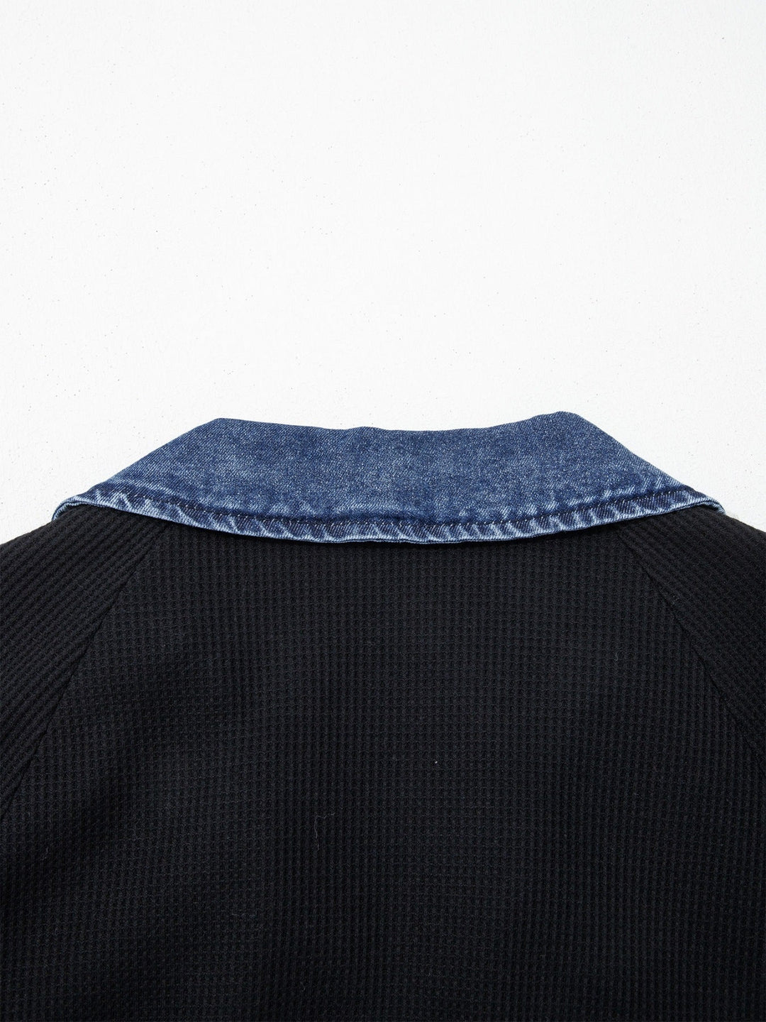 Denim-trim collar on black polo top, short sleeves
