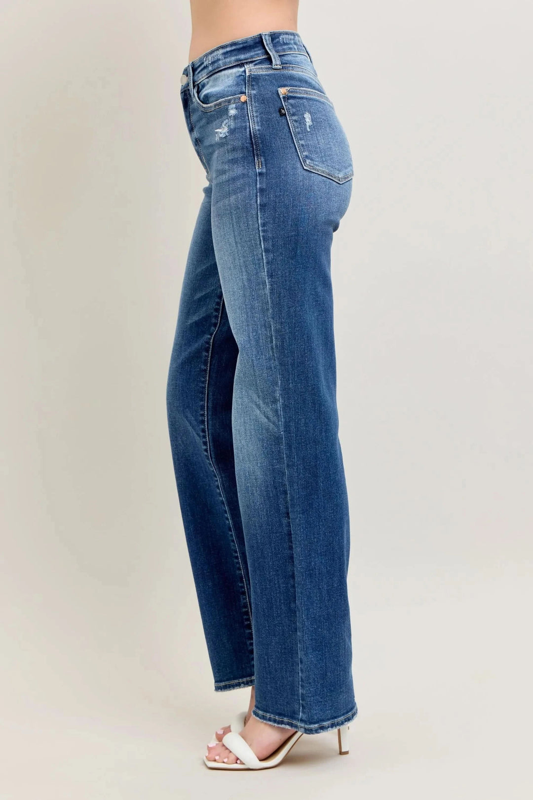 High-waist straight-leg jeans, side view, medium blue wash with stitched seam details