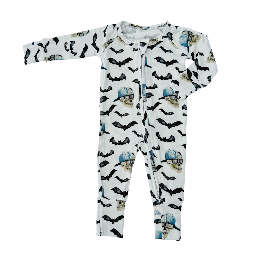 Spooky bamboo zippy pajamas, white with black bats and blue skulls, full-length one-piece