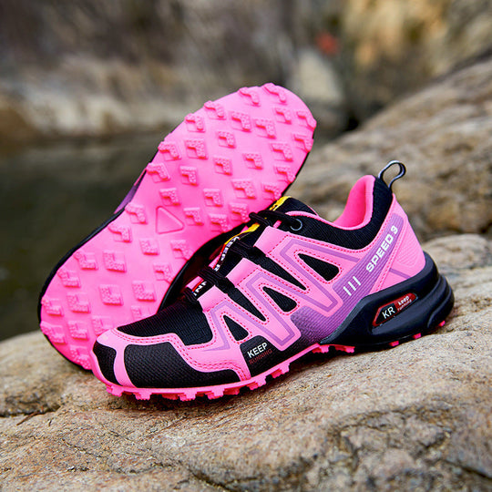 Pink and purple trail running shoe with black overlays and textured tread outsole.