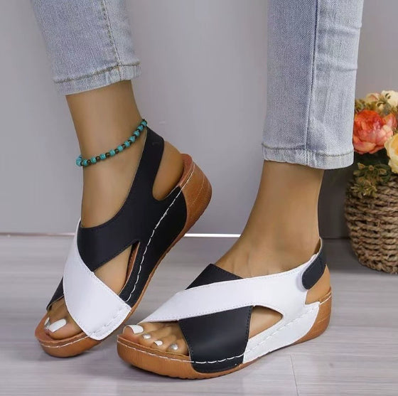 Black and white wedge sandals with crisscross cutouts and peep toe, platform bottom