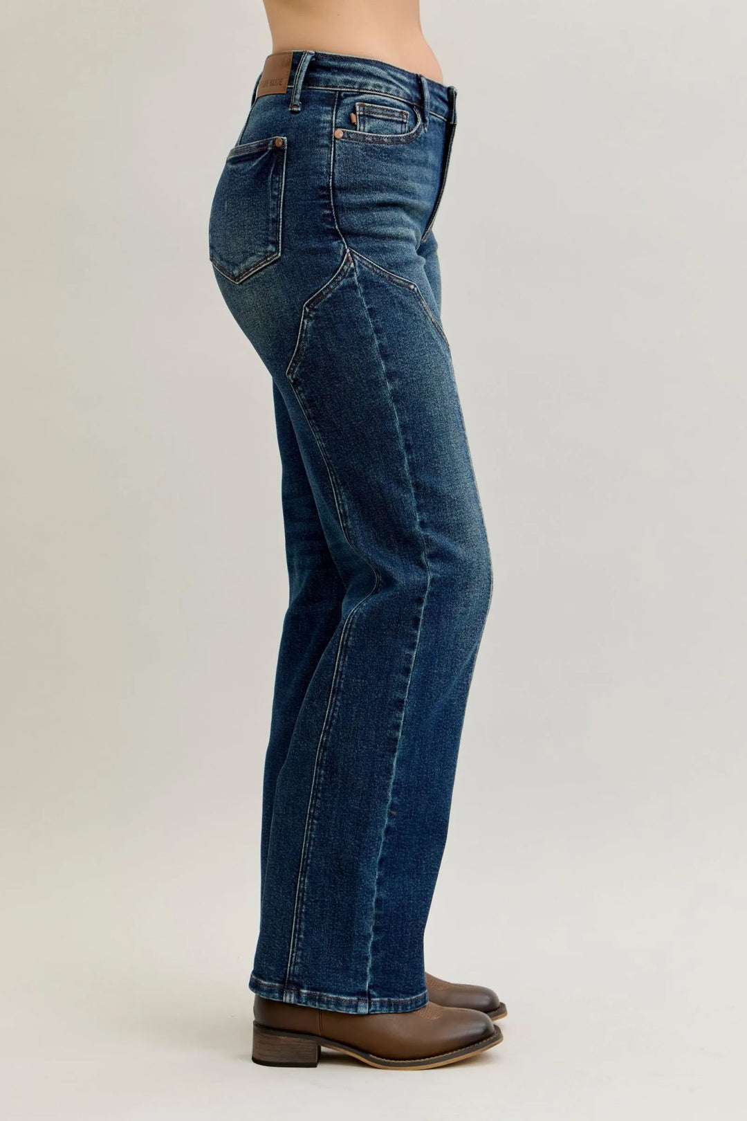 Dark straight-leg jeans, side view with seam detail and back yoke stitching