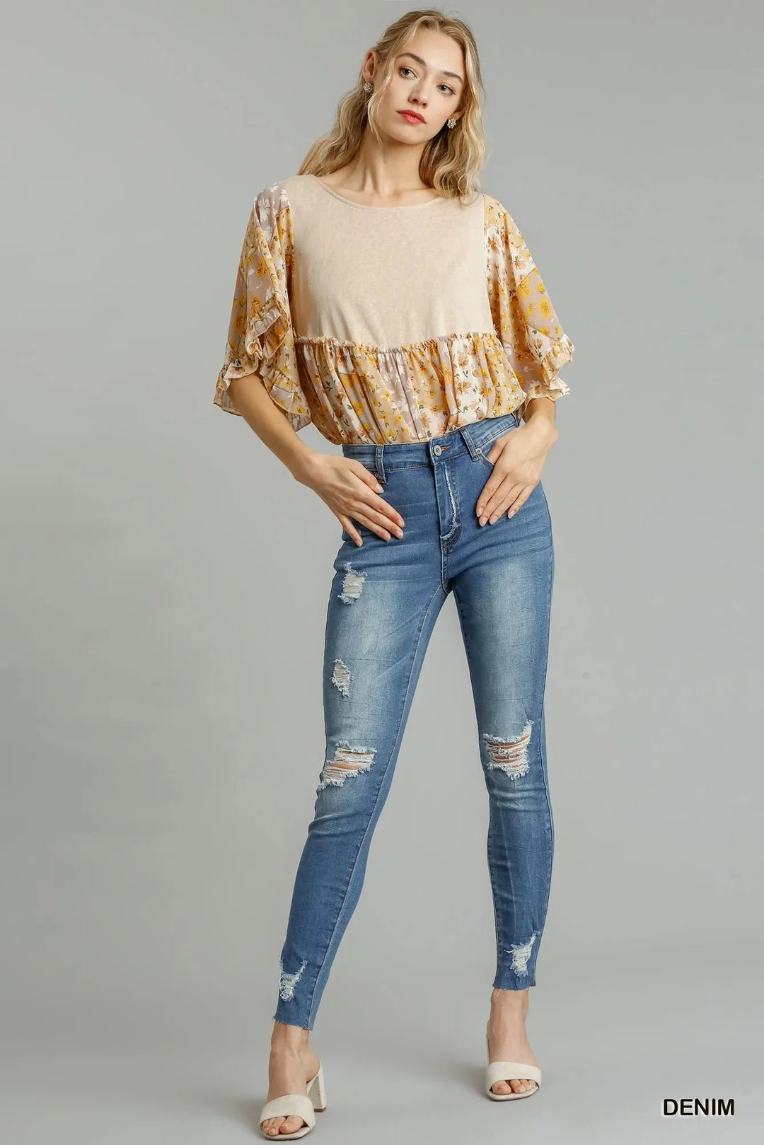 Medium wash high-waist distressed skinny jeans with raw hem; ankle-length fit