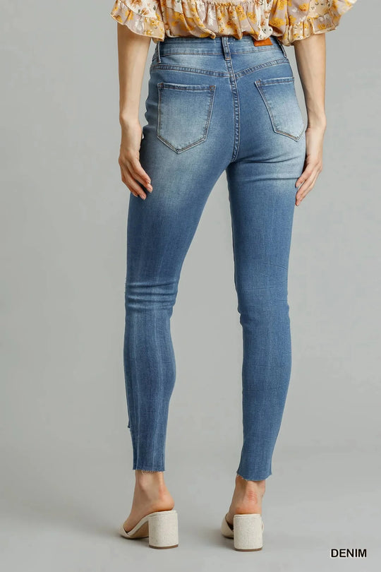 Medium wash high-waist skinny jeans, back view; five-pocket style, distressed finish