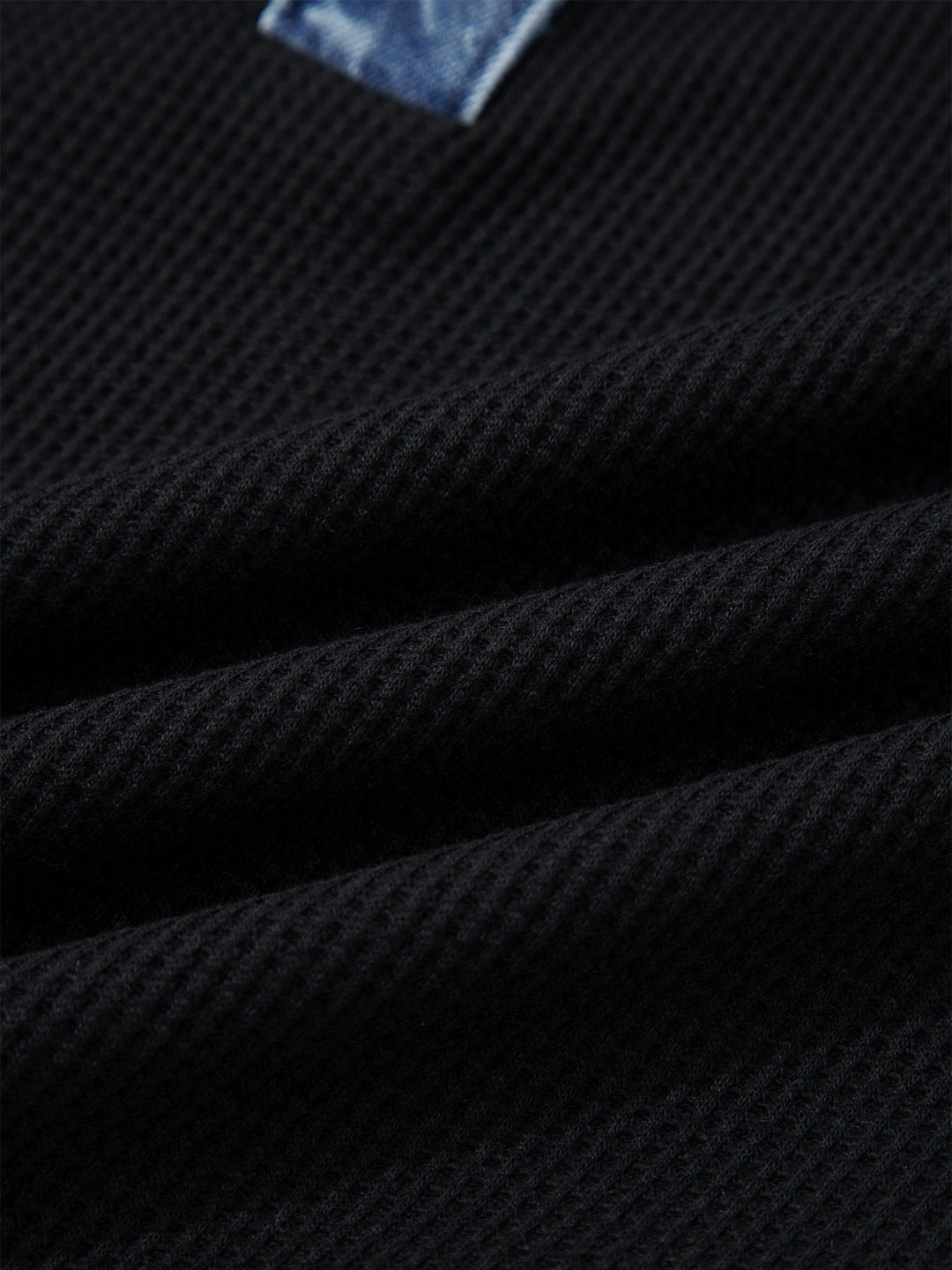 Black textured knit fabric on denim-trim button-detail top
