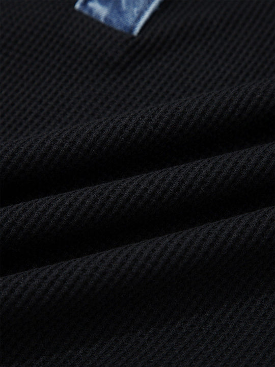 Black textured knit fabric on denim-trim button-detail top