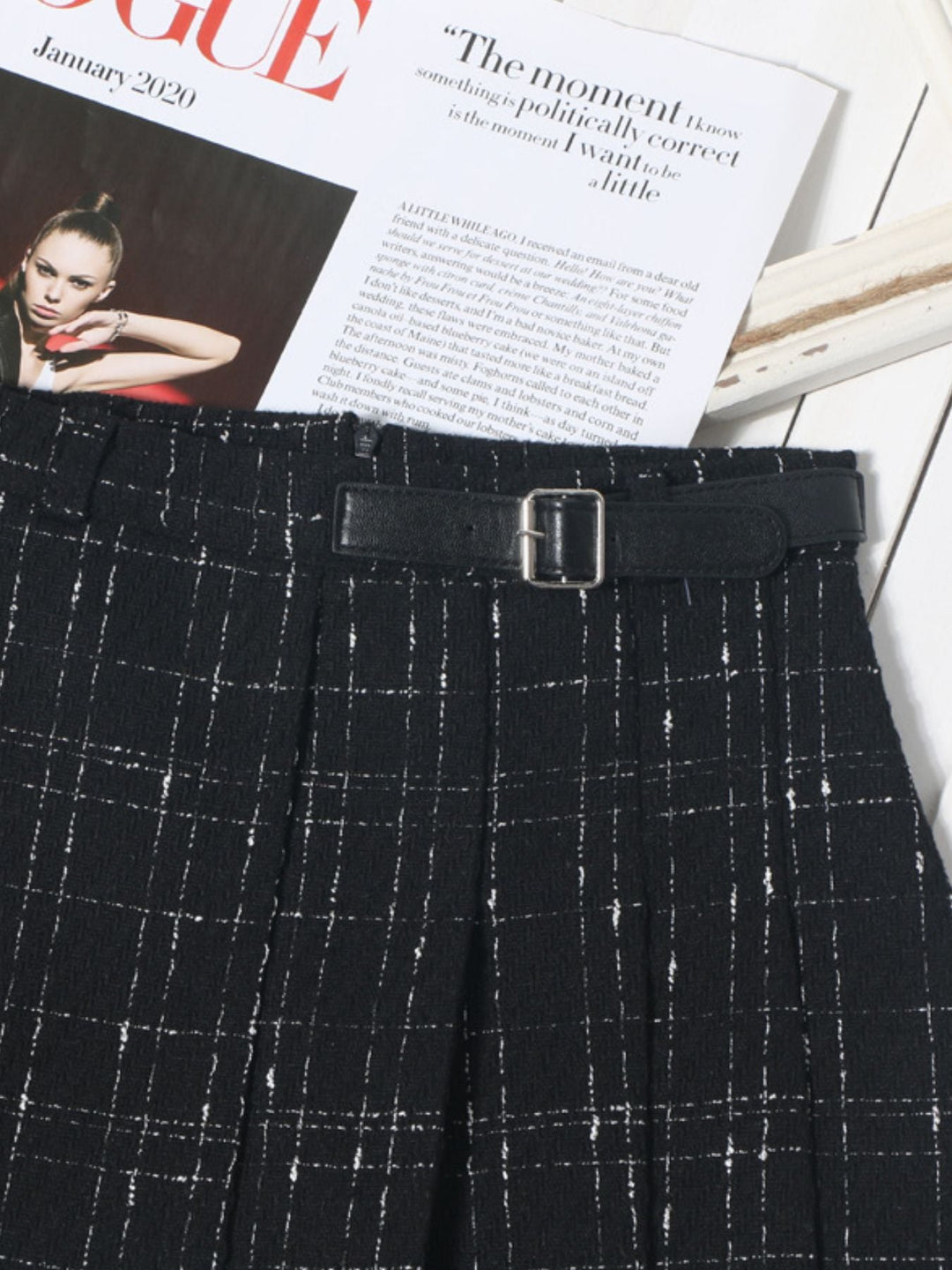 Black pleated plaid mini skirt with belt and evenly spaced white windowpane checks