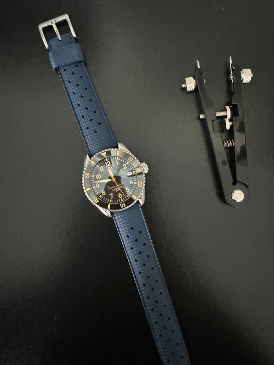 Tropic Bands watch with navy blue perforated strap and silver buckle, black dial