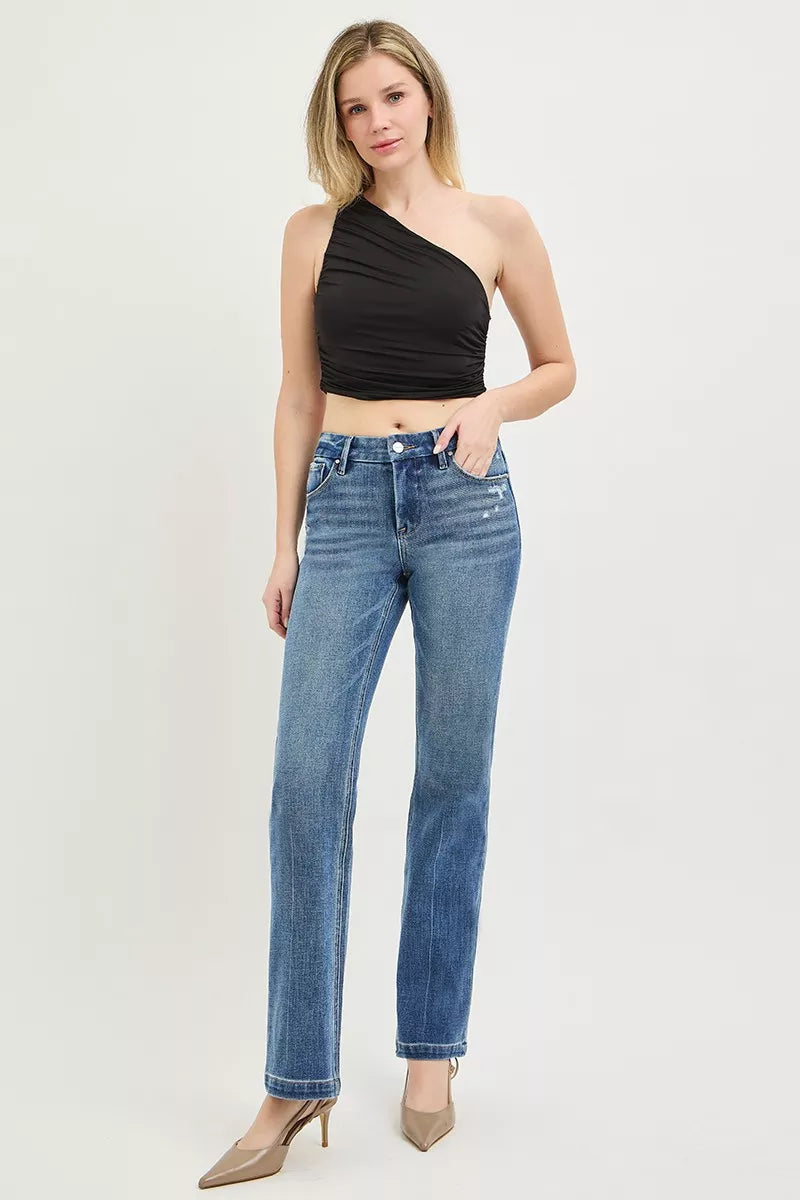 Medium wash straight jeans on model, mid-rise waist, button fly and belt loops