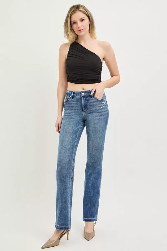 Medium wash straight jeans on model, mid-rise waist, button fly and belt loops