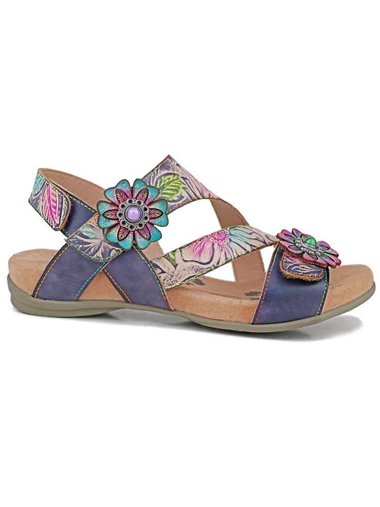 Boho sandals with purple leather straps, teal and pink flower studs, and tan footbed