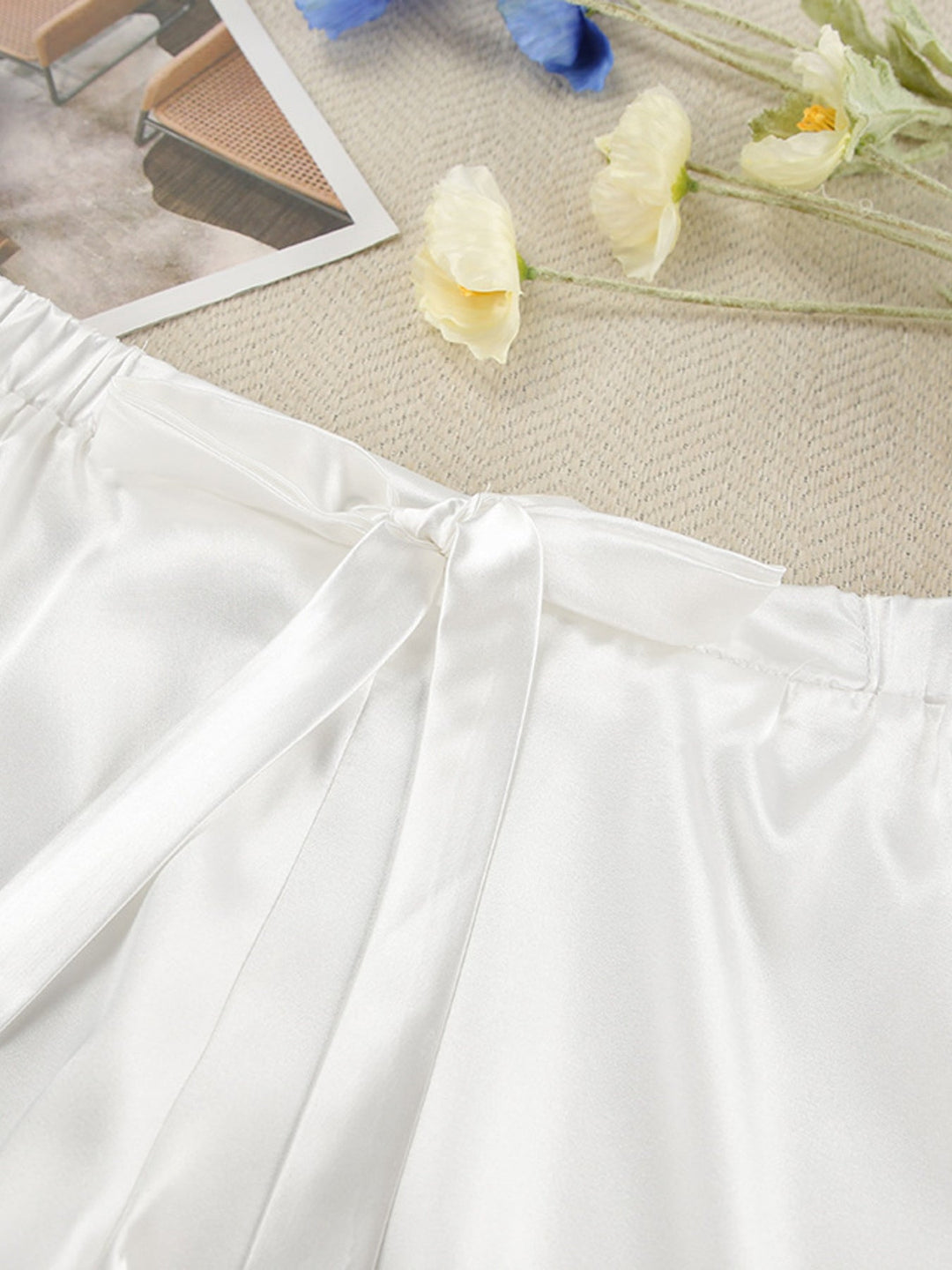 White gathered skirt panel with waist seam and tie at the top of the shorts