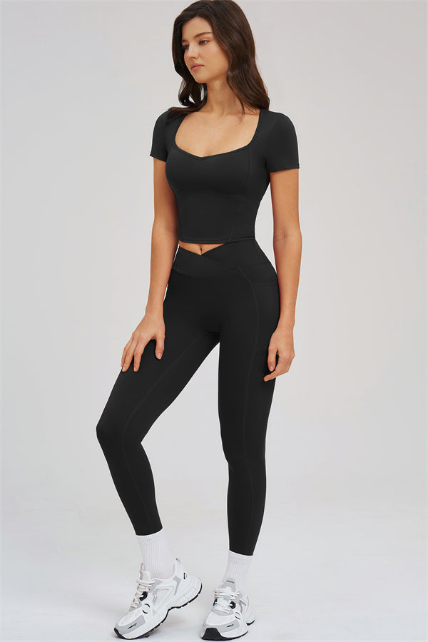 Black 2-piece set: side profile of high-rise leggings and fitted crop tee