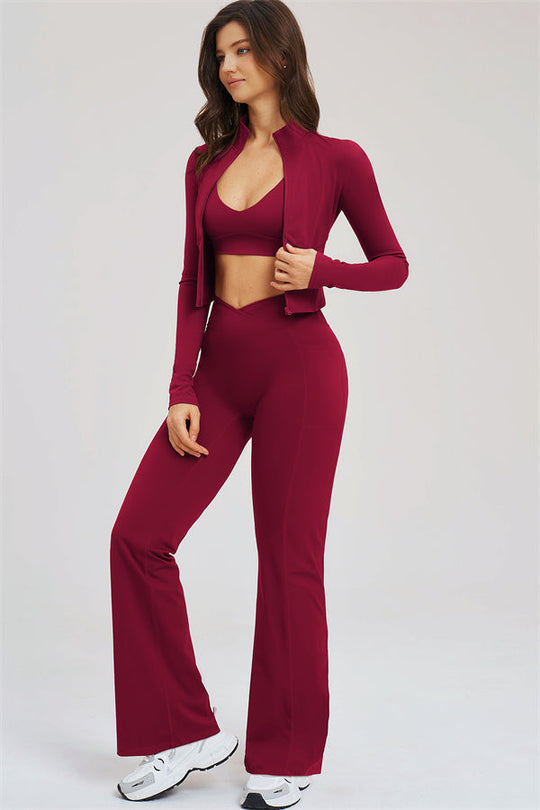 Burgundy zip jacket with sports bra and flared leggings, side view