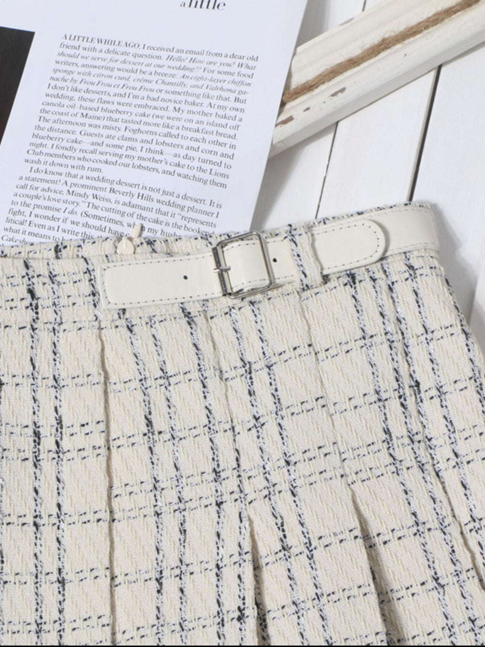 Beige pleated plaid mini skirt with white belt and silver buckle