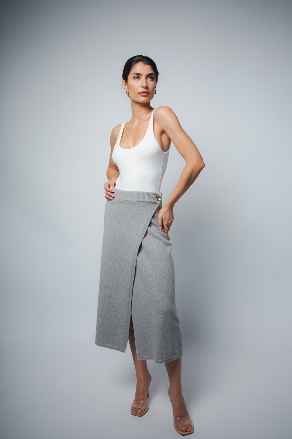 White tank bodysuit, fitted with scoop neckline and high-cut leg