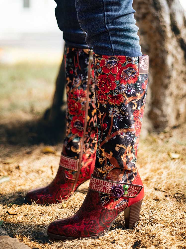 Floral tall boots on feet: black and red floral print with patterned side zipper panel