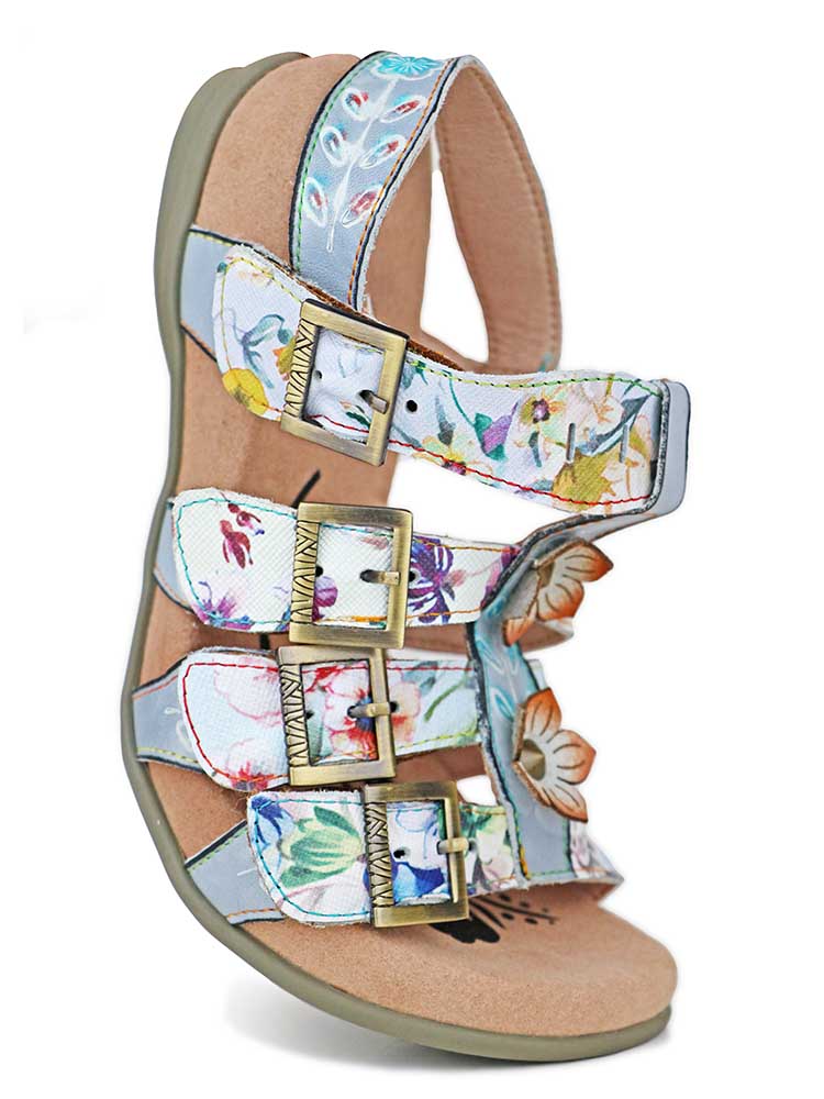 Close-up of floral bohemian leather sandal straps with gold buckles and heel support