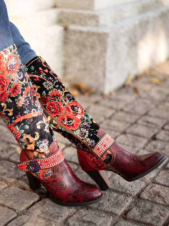 Side view of floral boots with red patterned toe, black floral shaft, and block heel