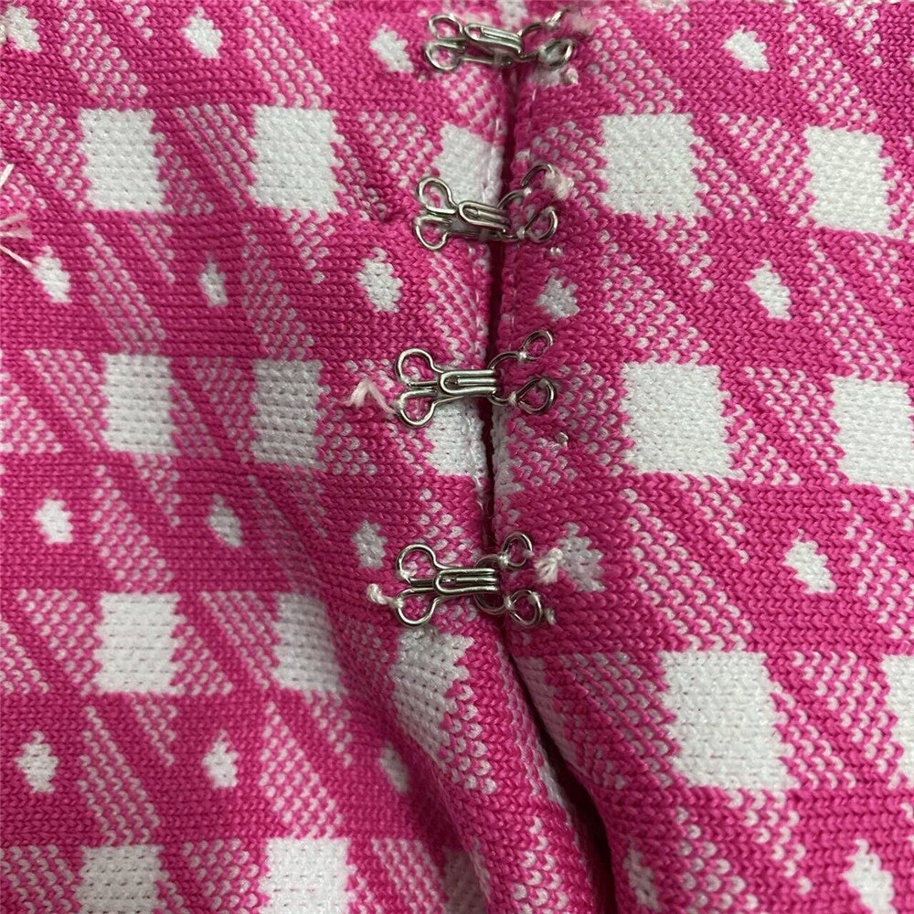 Pink knit skirt front with decorative hook-and-eye closures and trim