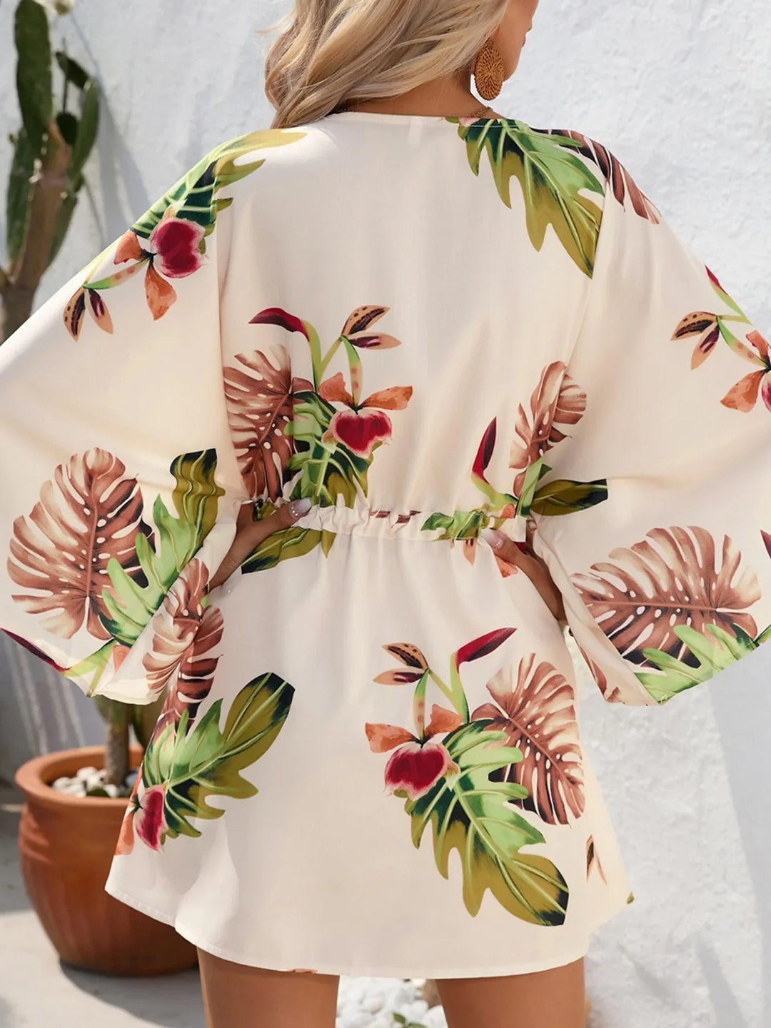 Floral print back view of button-up mini dress with elastic waist tie