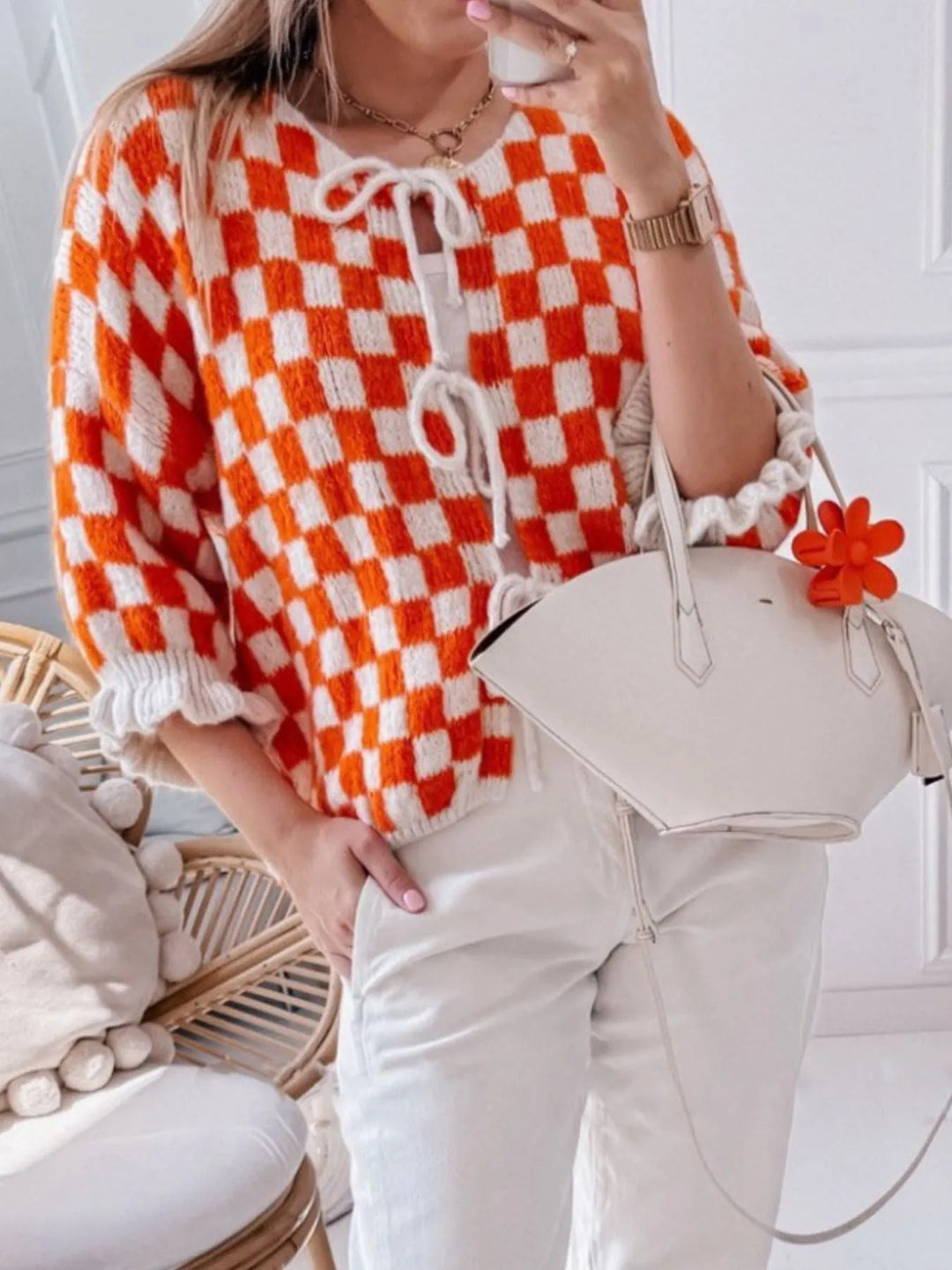 Checkered tie-front knit cardigan in orange and white, drawstring neckline, long sleeves