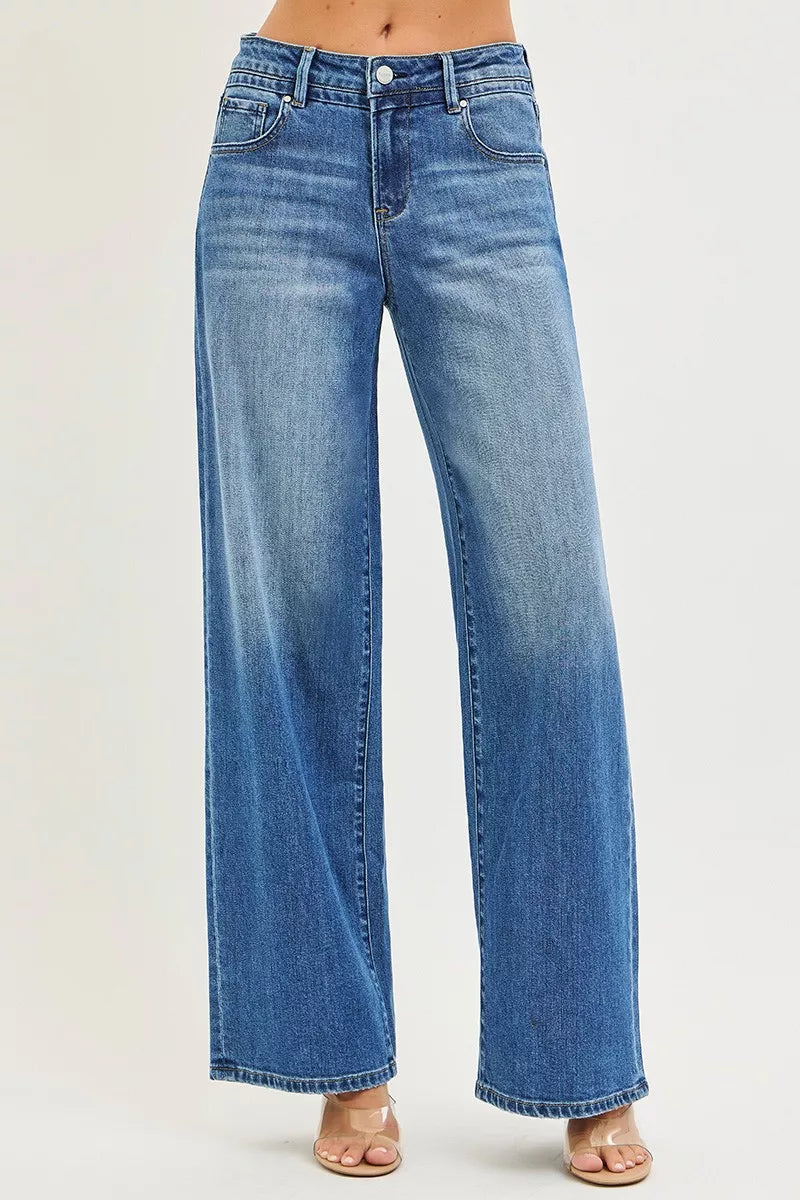 Medium-wash wide-leg baggy jeans with front pockets and zip fly