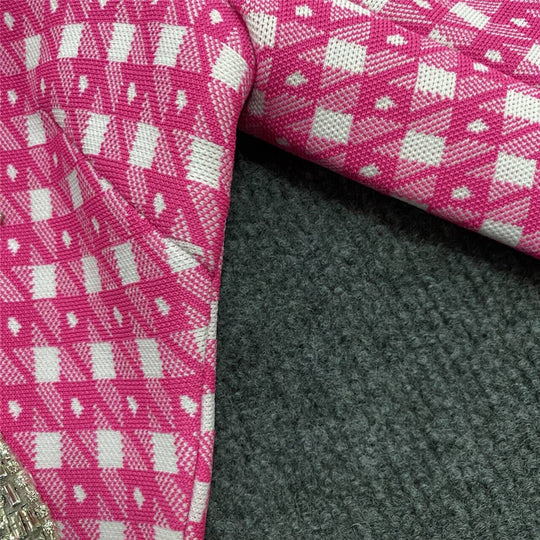 Pink knitted fabric close-up with small check pattern and textured weave