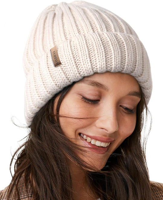 Cream chunky knit beanie with fleece lining and small leather brand patch