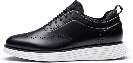 Black wingtip sneakers front view with perforated toe and stacked white sole