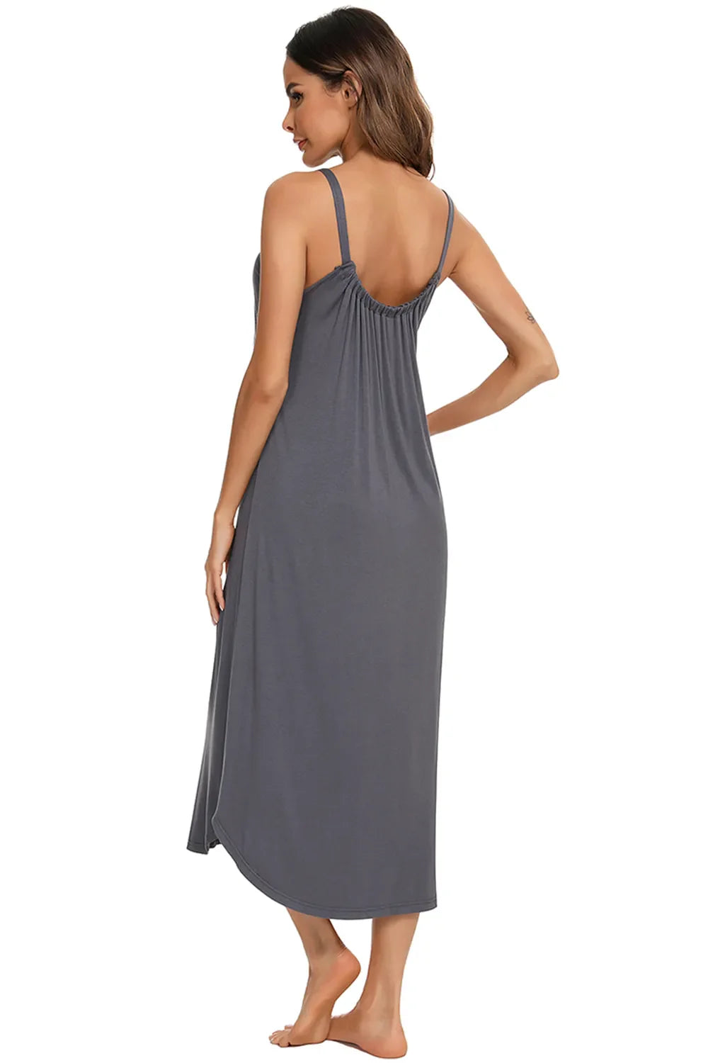 Back view of dark gray V-neck midi lounge dress with thin straps and draped skirt