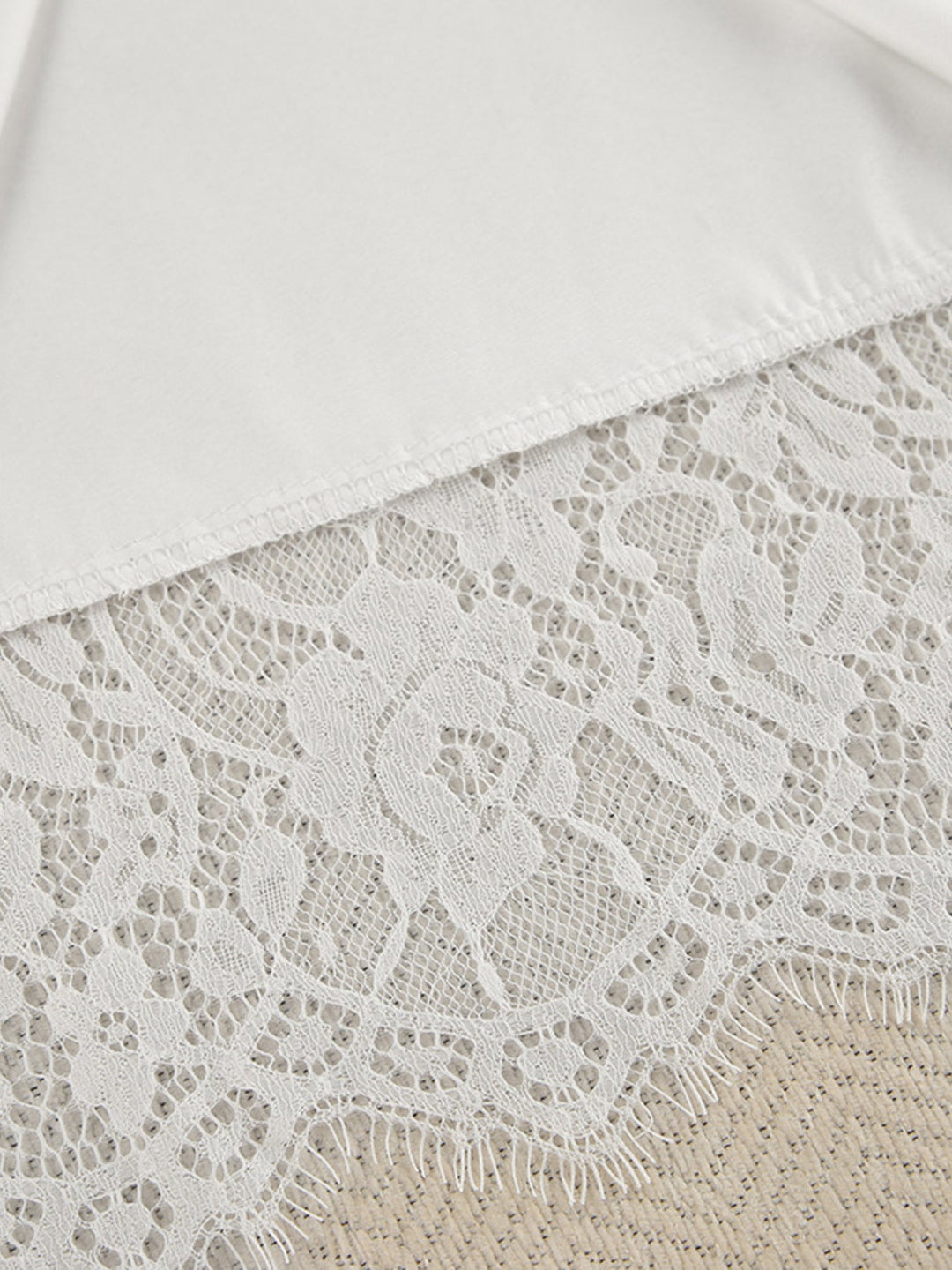 White lace trim on cardigan hem with scalloped edge