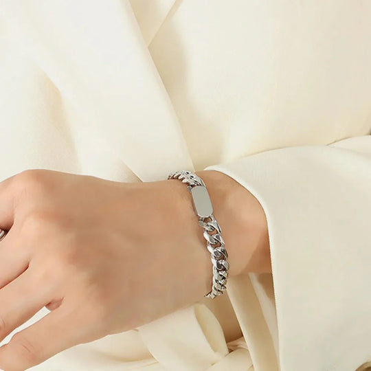 Golden Thread bracelet on wrist, silver curb-link chain with flat bar centerpiece