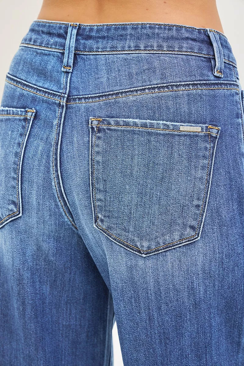 Medium-wash denim close-up: patch back pocket detail on baggy jeans