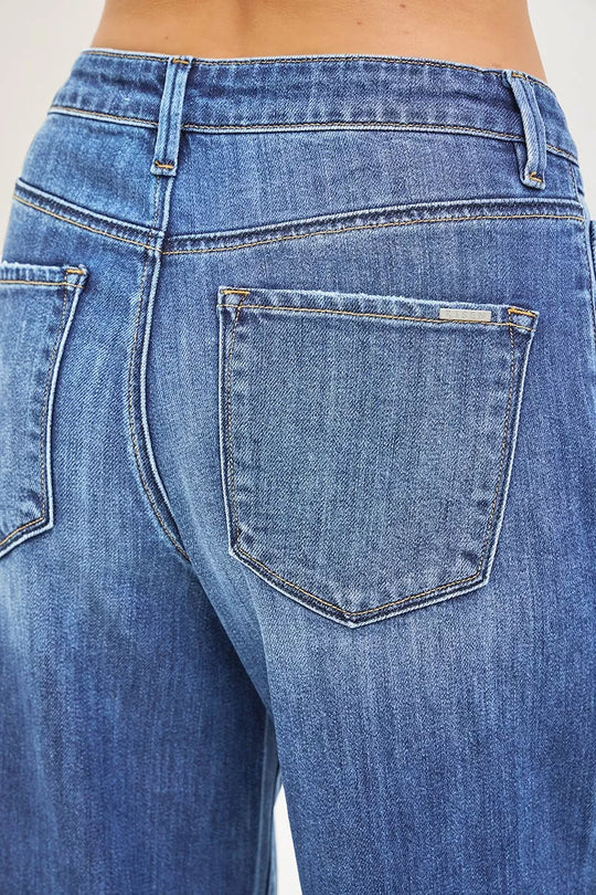 Medium-wash denim close-up: patch back pocket detail on baggy jeans