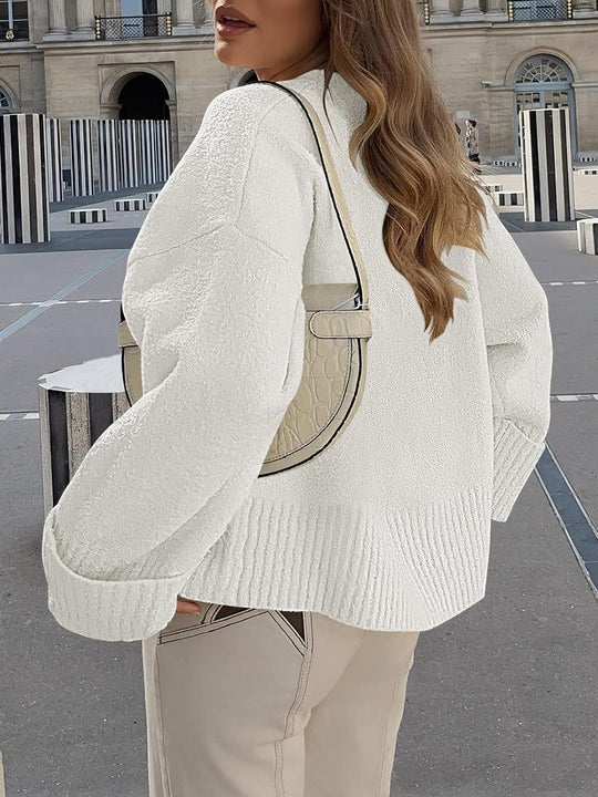 White fuzzy pullover side view with textured knit, ribbed hem, and cuffs